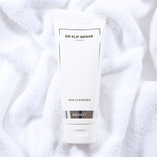 Dr Elif Benar AHA Cleanser 200ml tube on a soft white towel, exfoliating face wash with alpha hydroxy acids