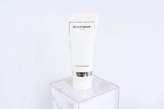 Dr Elif Benar AHA Cleanser 200ml tube standing on a clear acrylic cube