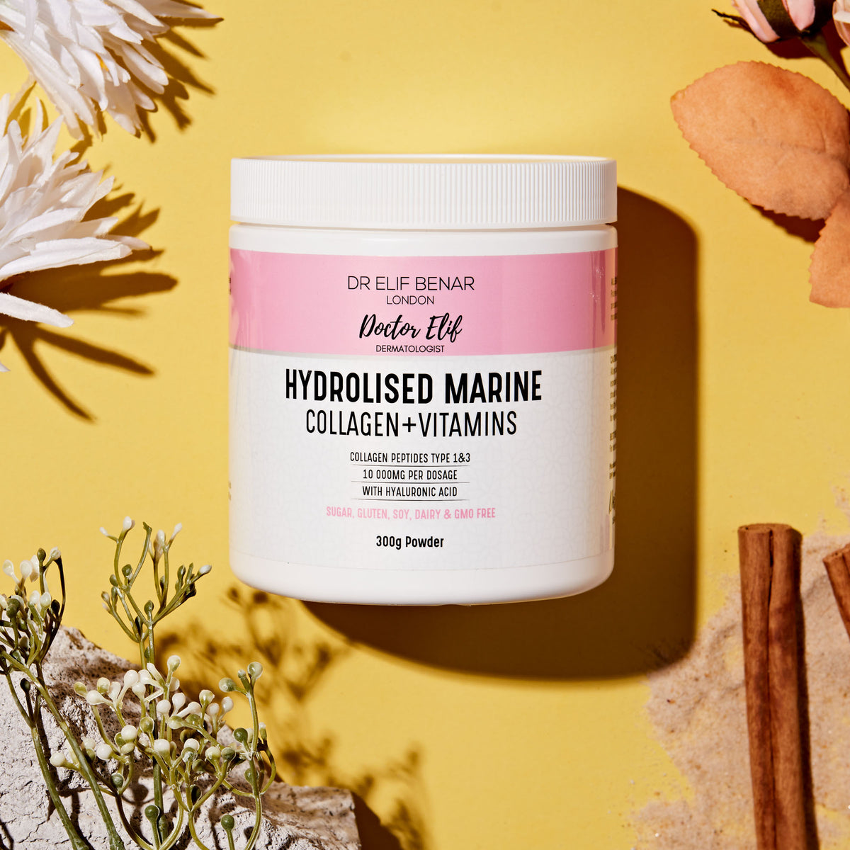 Dr Elif Benar Hydrolysed Marine Collagen + Vitamins tub on a yellow background with flowers and cinnamon